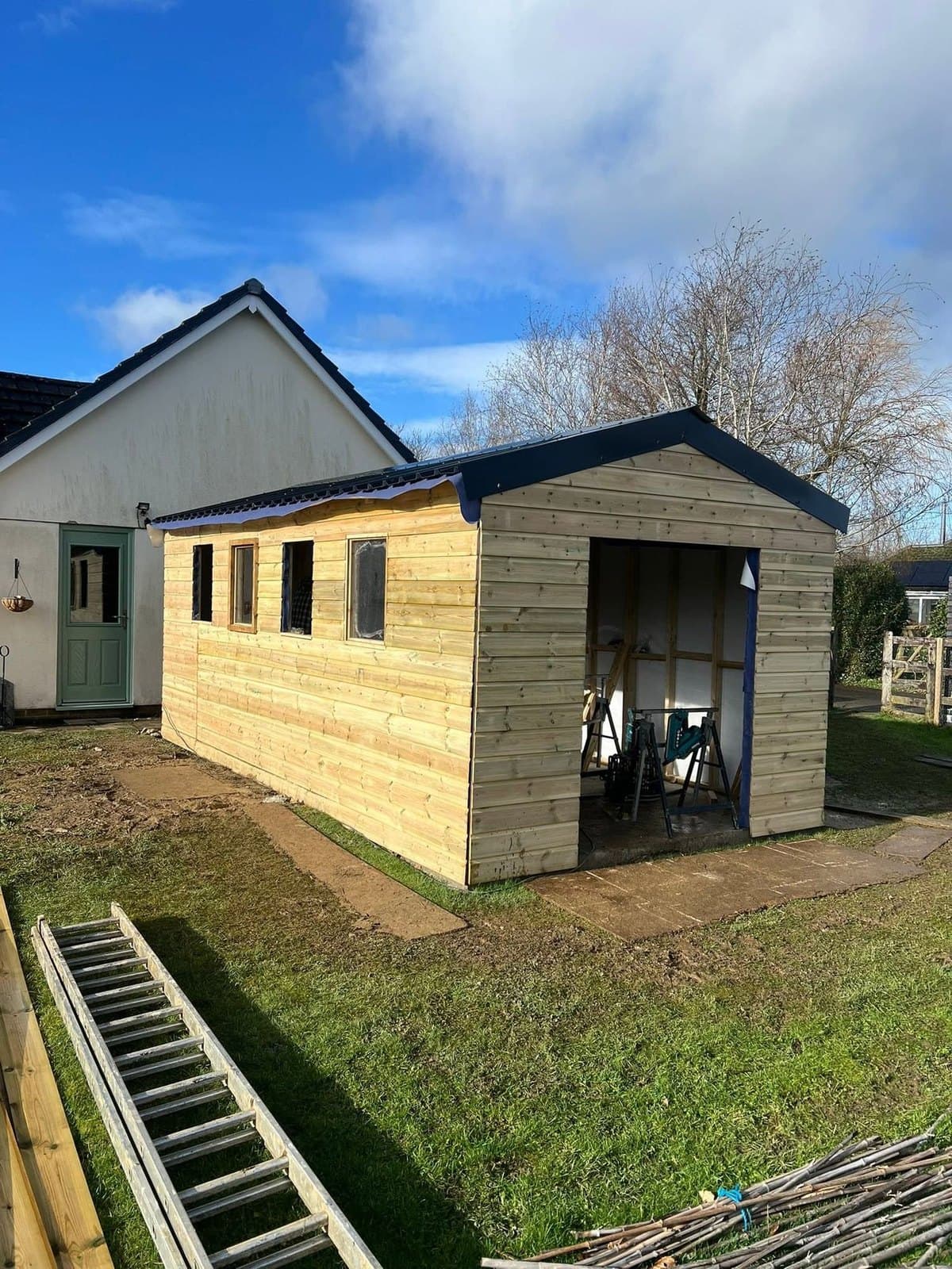 A garden room clad in pressure-treated timber with a pitched roof, built by Inside and Out Maintenance, North Devon