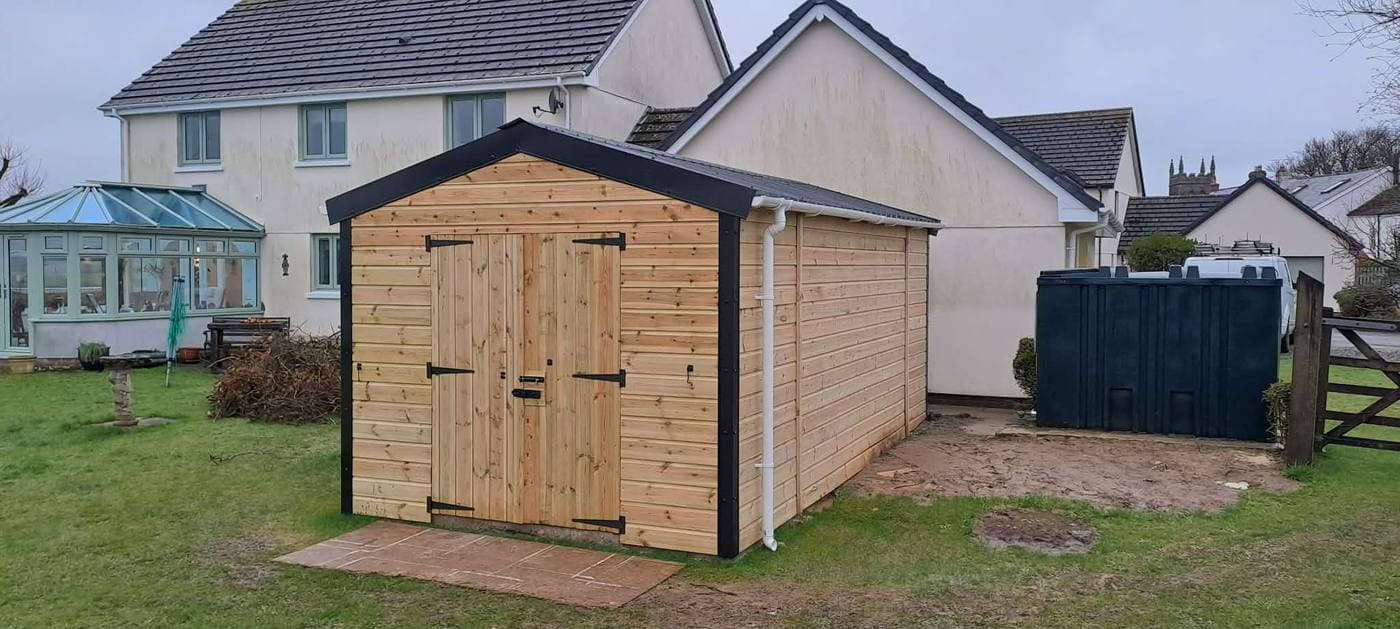 A finished bespoke timber shed with double doors, built on site by Inside and Out Maintenance, North Devon